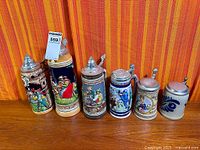 Front view of all six steins lined up