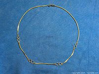 Full view of Sherman silvertone necklace laid flat