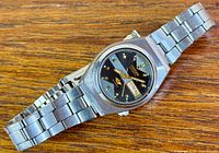 Front view of Citizen ladies automatic wristwatch on wooden surface