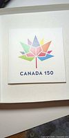 Front cover of presentation folder showing Canada 150 maple design