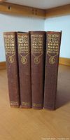 Spines of all four volumes showing leather, gilt titles, uniform height