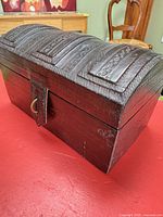 Three-quarter view showing domed lid tooling and latch