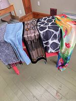 All five scarves draped over bench