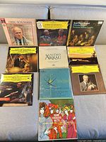 Single photo showing all 10 classical vinyl LP jackets laid out on a couch