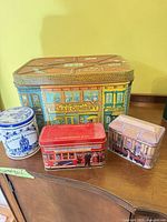 Group shot of four tins showing relative sizes and designs