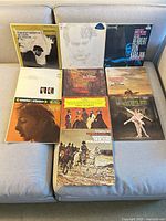Eight of the ten LP covers laid out on couch