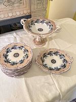 Compote and stack of plates showing overall design and quantity