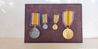 All four medals mounted on frame