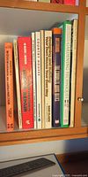 Shelf view showing nine book spines including woodworking, repair, architecture and gardening titles