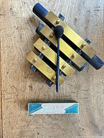 Tone chime block, one mallet, Hero harmonica case visible