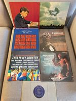 Front view of all seven LP records with jackets and one sleeved disc