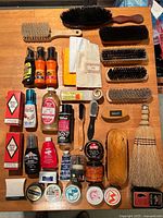 Overall view showing brushes, broom, cloths, polishes and tins