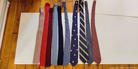 All ten ties laid out side by side to show full length and colour range