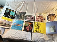 All 10 LP jackets laid out on sofa, front cover artwork visible