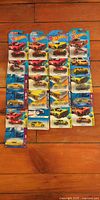 All carded Hot Wheels vehicles laid out on floor