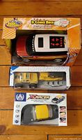 Three boxed toy vehicles stacked: Road Rippers Ford Flex, 4x4 Jeep with trailer, XRacer RC car