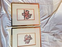 Both framed prints front view on cloth