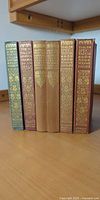 Front spines of five of the six Dent gilt cloth volumes standing upright