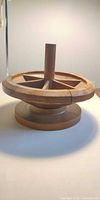 Overview of lathe-turned wheel pattern showing spokes, central column and base disc