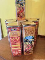 Front and side view of stacked Lancia pasta tins showing graphics