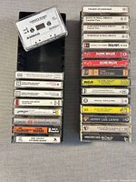 Two columns of cassette tapes showing mix of jazz, big band and rock titles; clear cases and label information visible