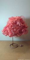 Front view of pink petal hat on metal stand