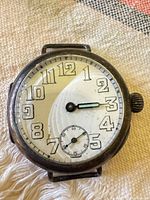 Front view of dial showing numerals, hands and sub-seconds dial