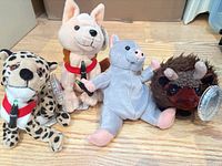 Group photo of all four Coca-Cola plush animals