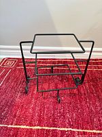 Assembled black metal stand with top ceramic plate