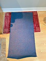 Full view of blue flecked carpet remnant on floor