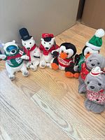 All seven plush animals lined up on floor