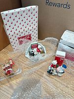 All three figurines with original boxes and protective packaging visible