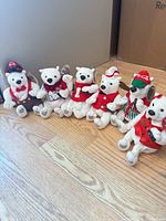 All six polar bear plush toys lined up on floor