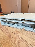 Overall view of four-tier plastic letter tray stack showing two-column arrangement