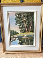 Front view of framed landscape painting