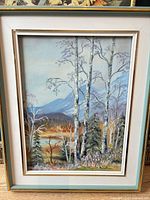 Front view of framed vertical landscape painting showing artwork, mat and frame