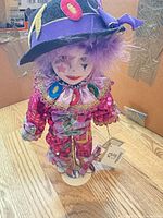 Full view of Kingstate clown doll on metal stand showing costume, hat and tags
