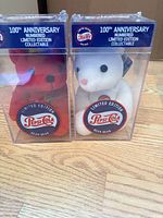 Front view of both bears in clear cases showing Pepsi-Cola logos and colors