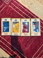 Front view of all four boxed bears on rug