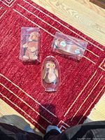 Group shot showing three Ty Beanie Babies in separate clear display cases