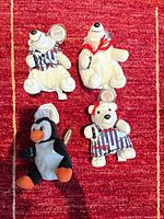 All four Coca-Cola plush toys displayed together