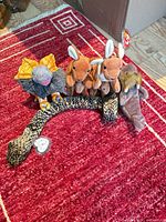 All five Ty Beanie plush toys grouped together on red rug: two kangaroos, frilled-neck lizard, snake, walrus