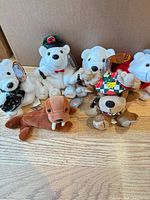 Group shot of all six Coca-Cola plush characters