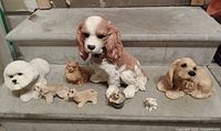 Group shot of all eight dog figurines on step