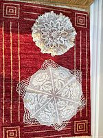 Two primary doilies laid flat showing patterns and scale