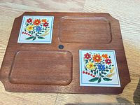 Full view of wooden board showing two ceramic tiles and recessed sections