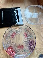 Overview of black tray, clear pedestal bowl, iridescent platter
