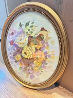 Full view of oval framed floral painting
