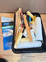 Overview of tray and contents including sandpaper pack