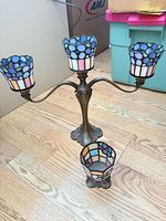 Full view of 3-arm candelabra with three shades and separate votive cup